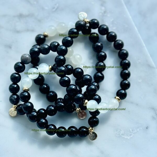 Black beaded bracelets with white beads.