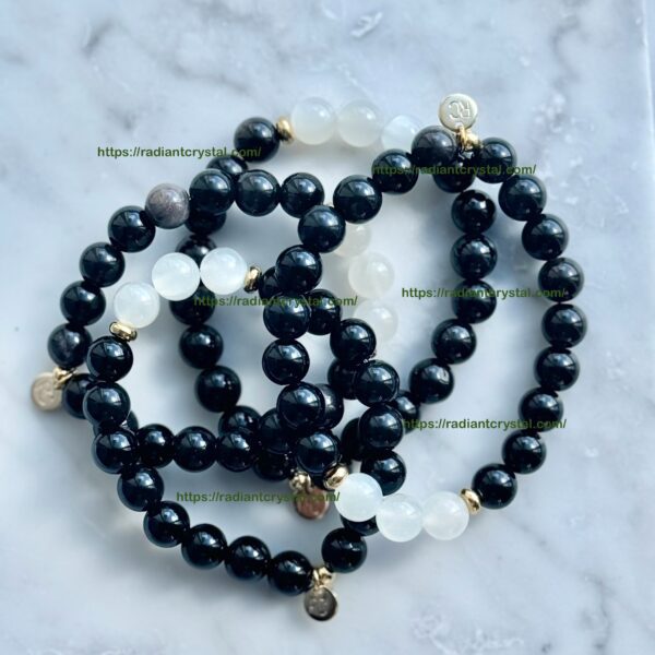 Black and white beaded bracelets with charms.