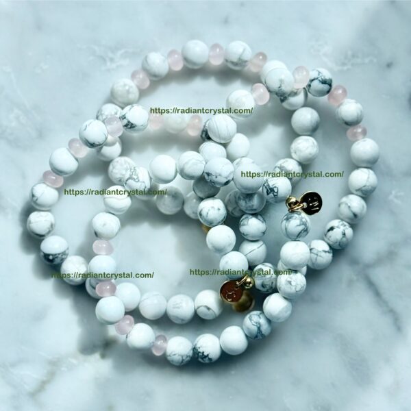 White and pink beaded bracelets with charms.