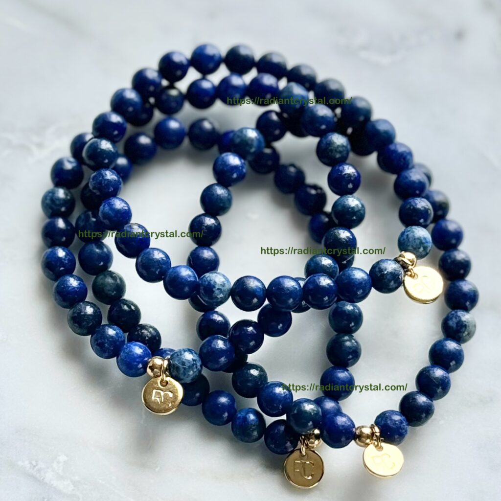 Three blue beaded bracelets with gold charms.