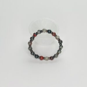 A bracelet with red and black beads on it