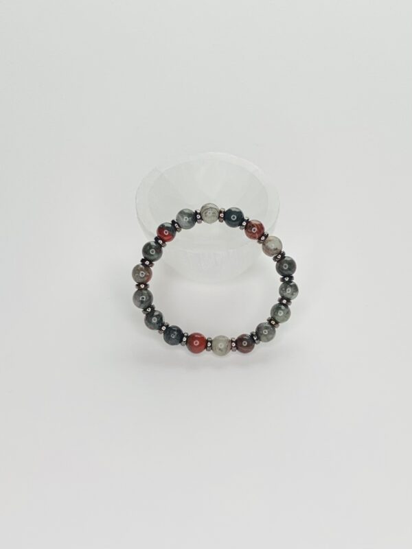 A bracelet with red and black beads on it