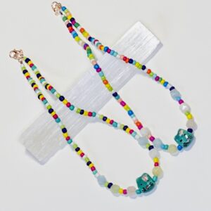 A necklace with colorful beads and a blue glass bead.