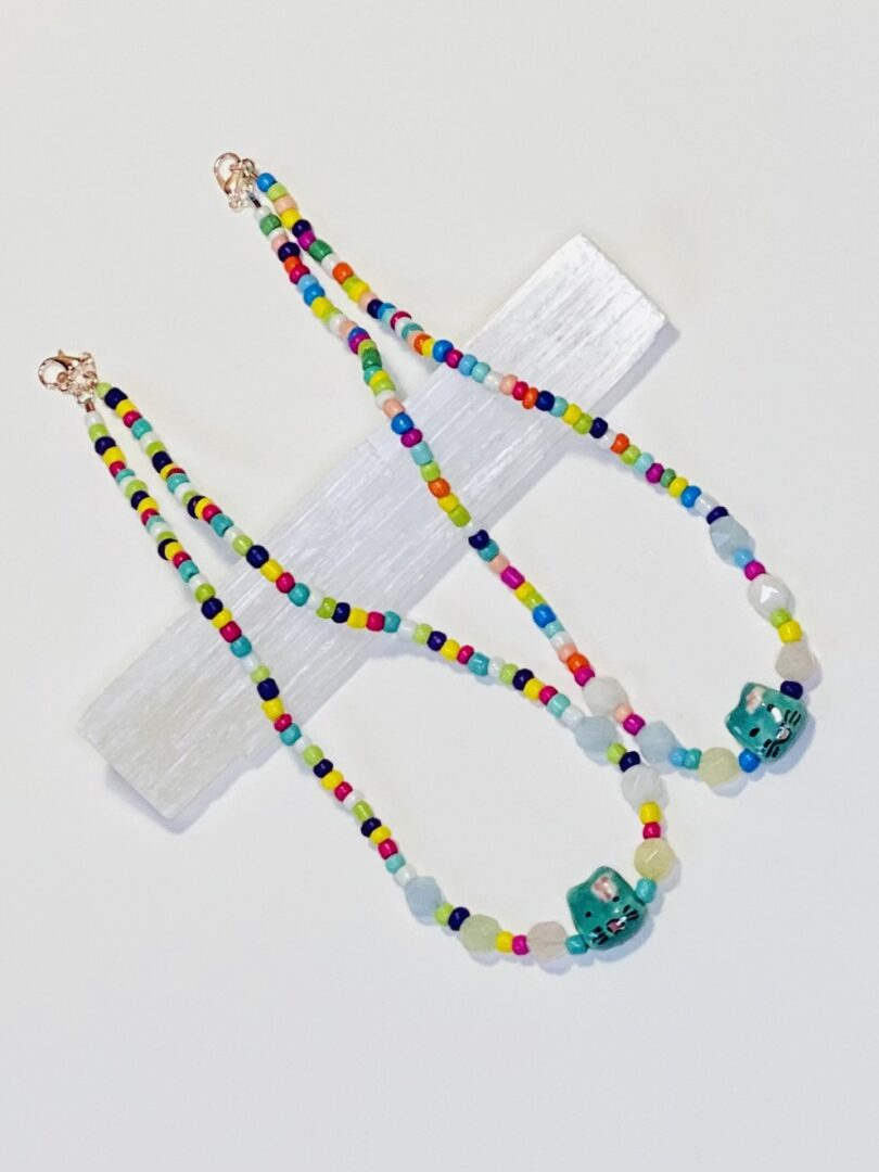 A necklace with colorful beads and a blue glass bead.