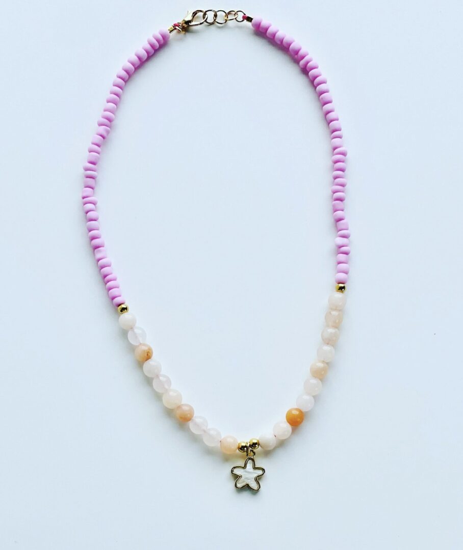 A necklace with pink beads and a star charm.