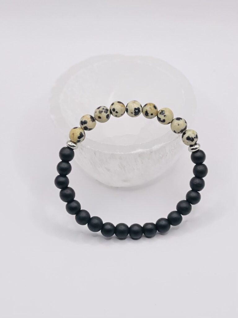 A black and white bracelet is sitting on top of a table.