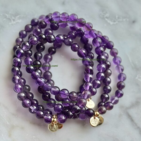 Amethyst bead bracelets with gold charms.