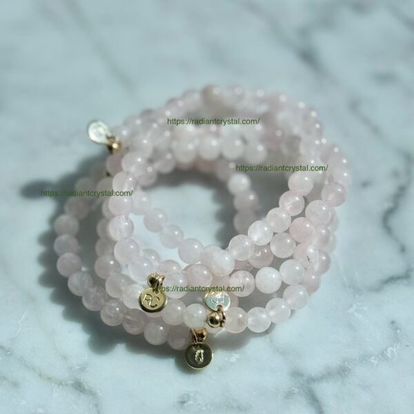 Rose quartz beaded bracelets with gold charms.