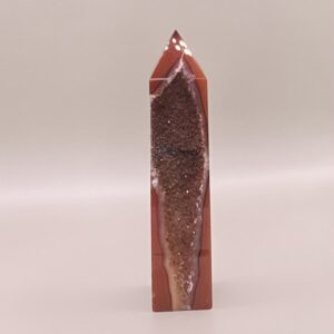 A Carnelian Druzy Tower-A on a white surface.