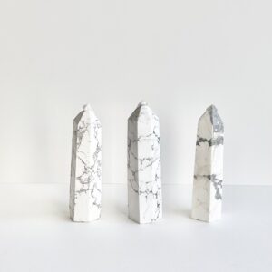 Three Howlite Towers on a white surface.