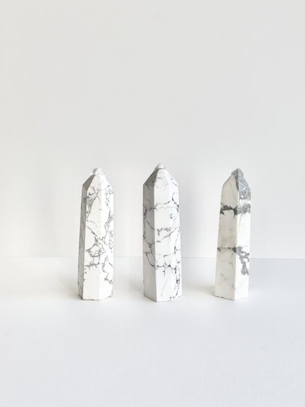 Three Howlite Towers on a white surface.