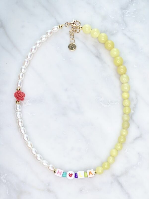 A Dream Amethyst Necklace with yellow beads and a heart charm.