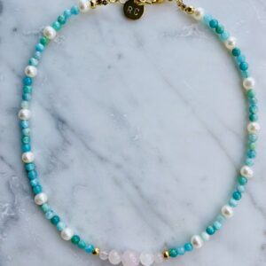 An Amazonite-Rose Quartz & Pearls Choker on a marble table.