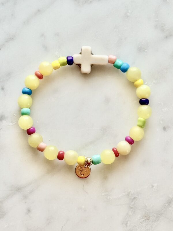 Colorful beaded bracelet with cross charm.