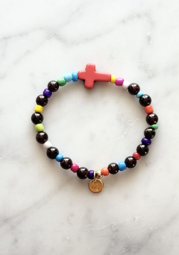 Colorful beaded bracelet with cross charm.