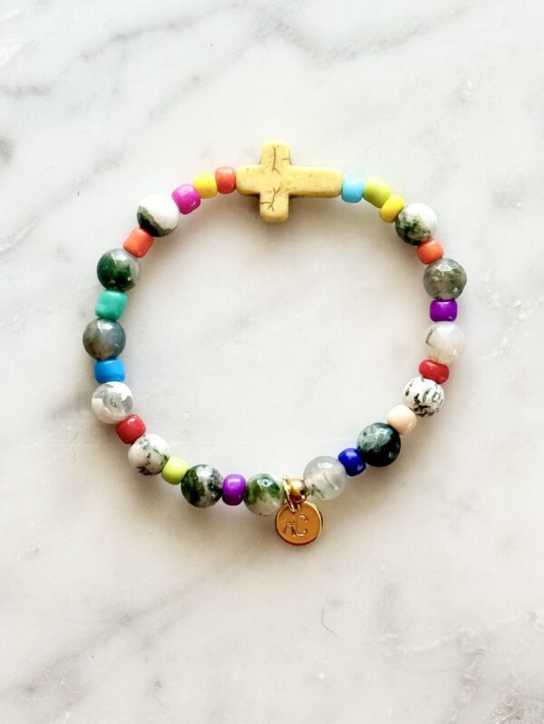 Colorful beaded bracelet with a cross charm.