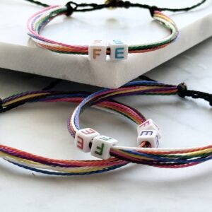 Rainbow string bracelets with letter beads.