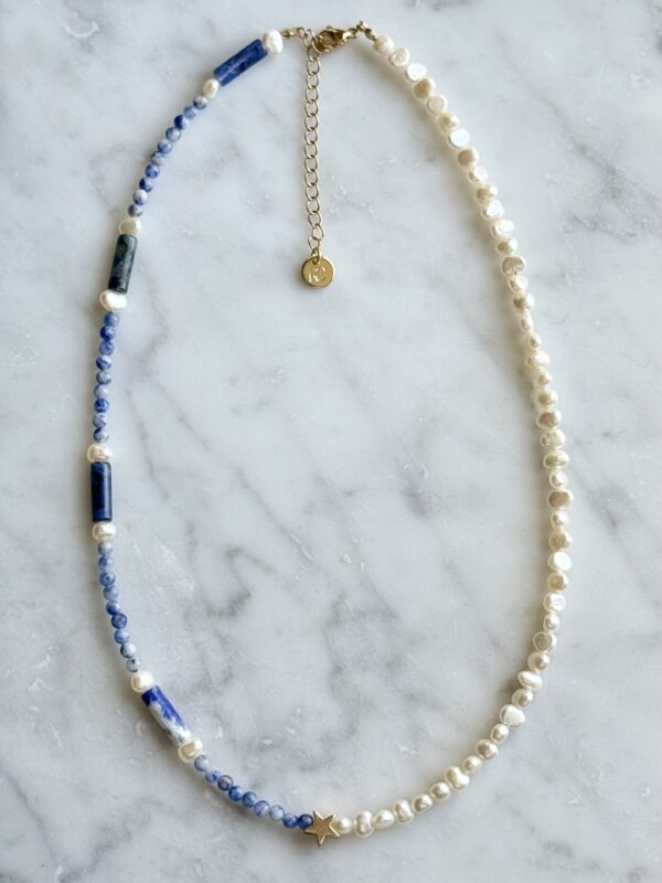 Blue and white pearl necklace with gold star.