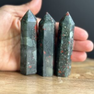 Three green and red gemstone points.
