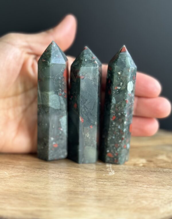 Three green and red gemstone points.