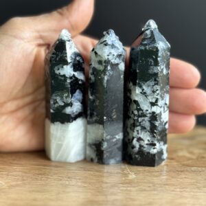 Three black and white gemstone points.