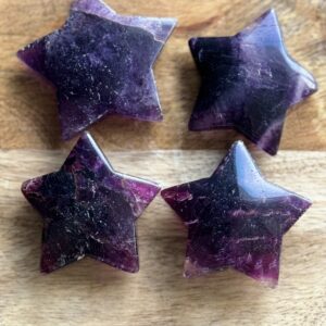 Four purple fluorite star shaped crystals.