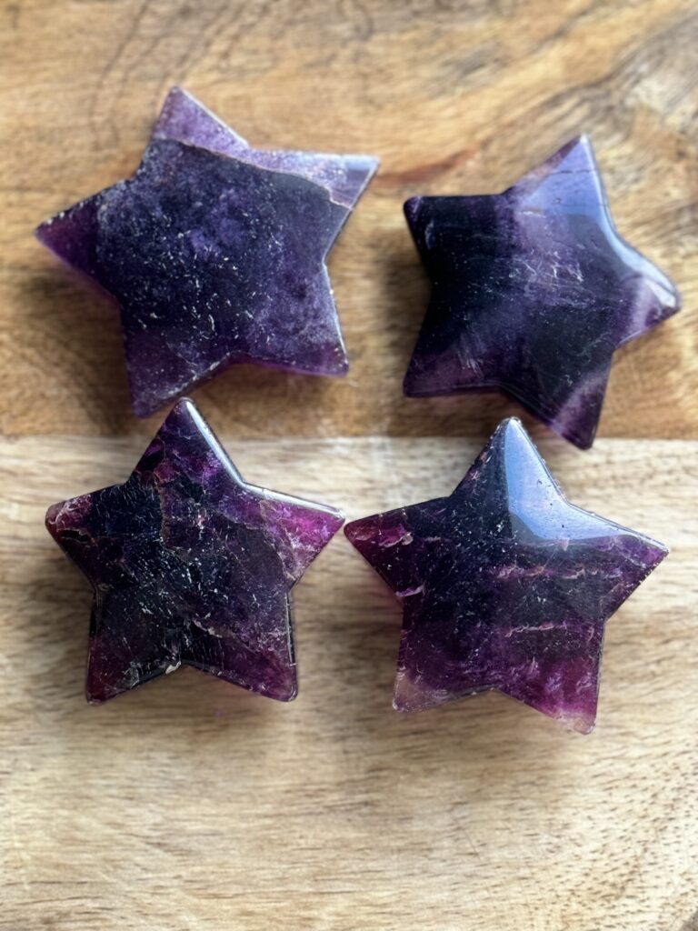 Four purple fluorite star shaped crystals.