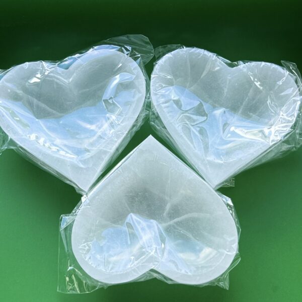 Three white heart-shaped silicone molds.