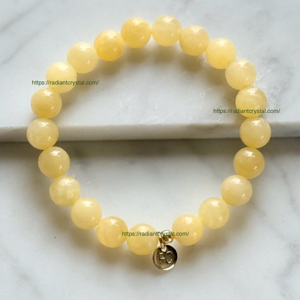 Yellow jade beaded bracelet with gold charm.