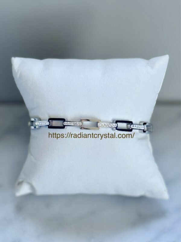 Diamond chain bracelet on white pillow.