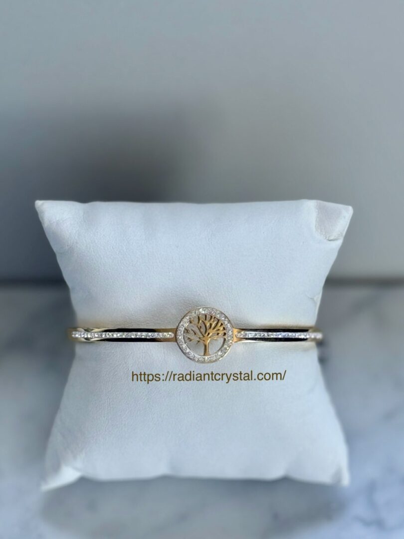 Gold bracelet with tree of life charm.