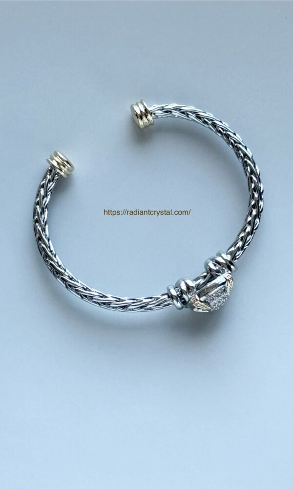 Silver and gold braided bracelet with diamonds.