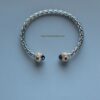 Silver and gold bangle with gems.