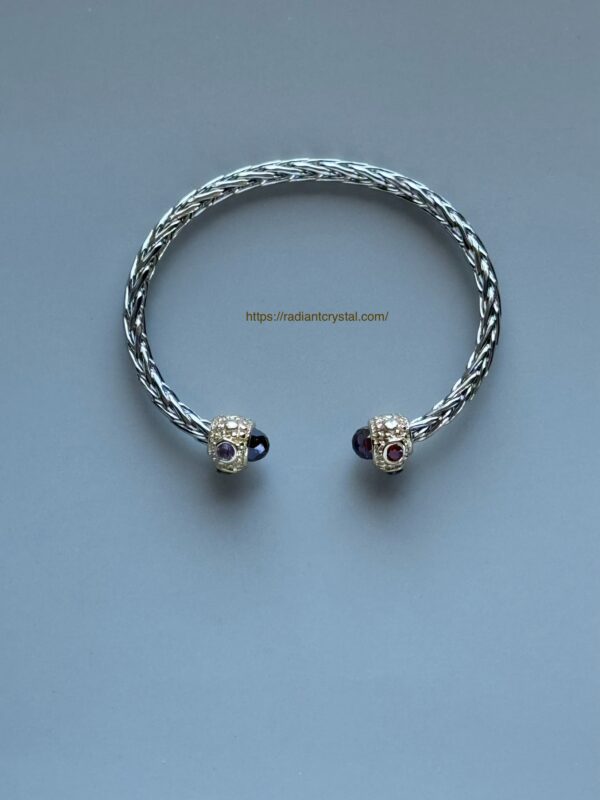 Silver and gold bangle with gems.