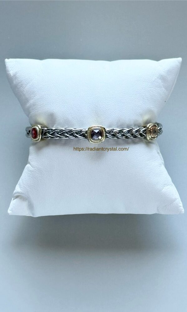 Silver and gold braided bracelet with gems.