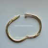 Gold nail-shaped bracelet with diamond.