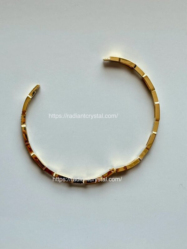 Gold bracelet with square stones.