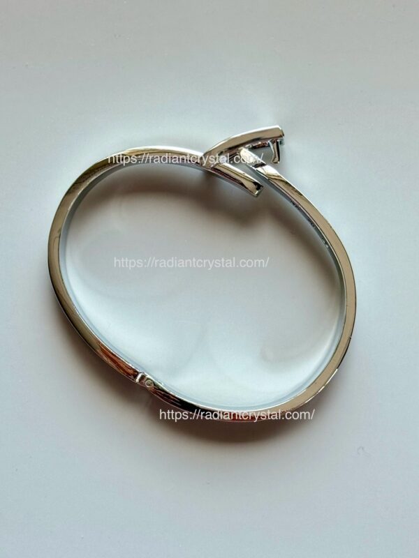 Silver bangle bracelet with crystal.