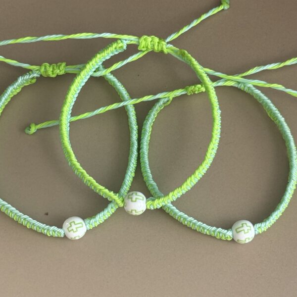 Three green and white friendship bracelets.