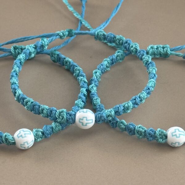 Three blue prayer bracelets with crosses.