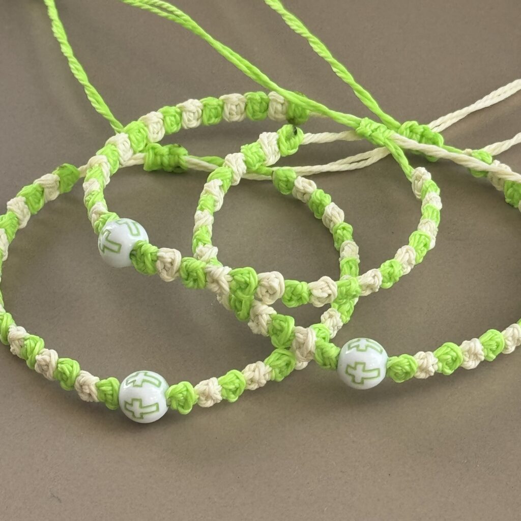 Three green and white beaded bracelets.