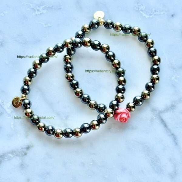 Two beaded bracelets with a rose charm.