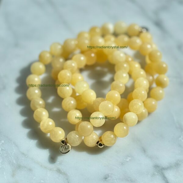 Yellow gemstone beaded bracelet with gold charm.