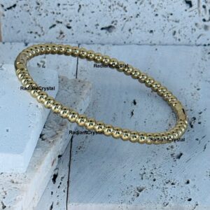 Gold beaded bracelet, elegant jewelry.