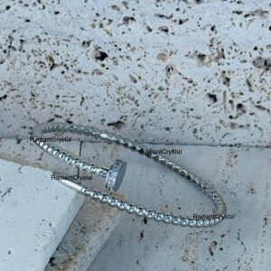 Silver beaded nail bracelet with stones.