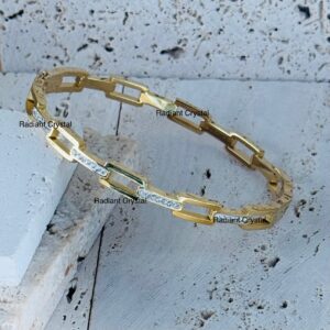 Gold chain bracelet with clear stones.