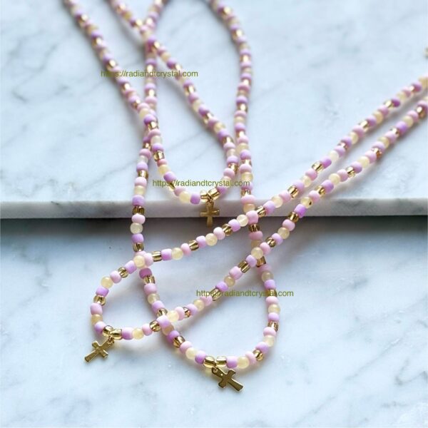 Pink and gold beaded cross necklace.