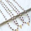 Three beaded necklaces with gold crosses.