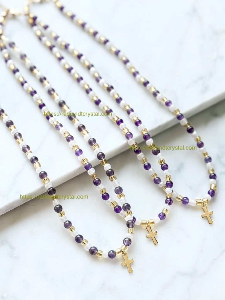 Three beaded necklaces with gold crosses.