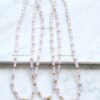 Three beaded necklaces with gold crosses.